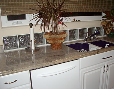 Horizontal glass block window backing kitchen counter.